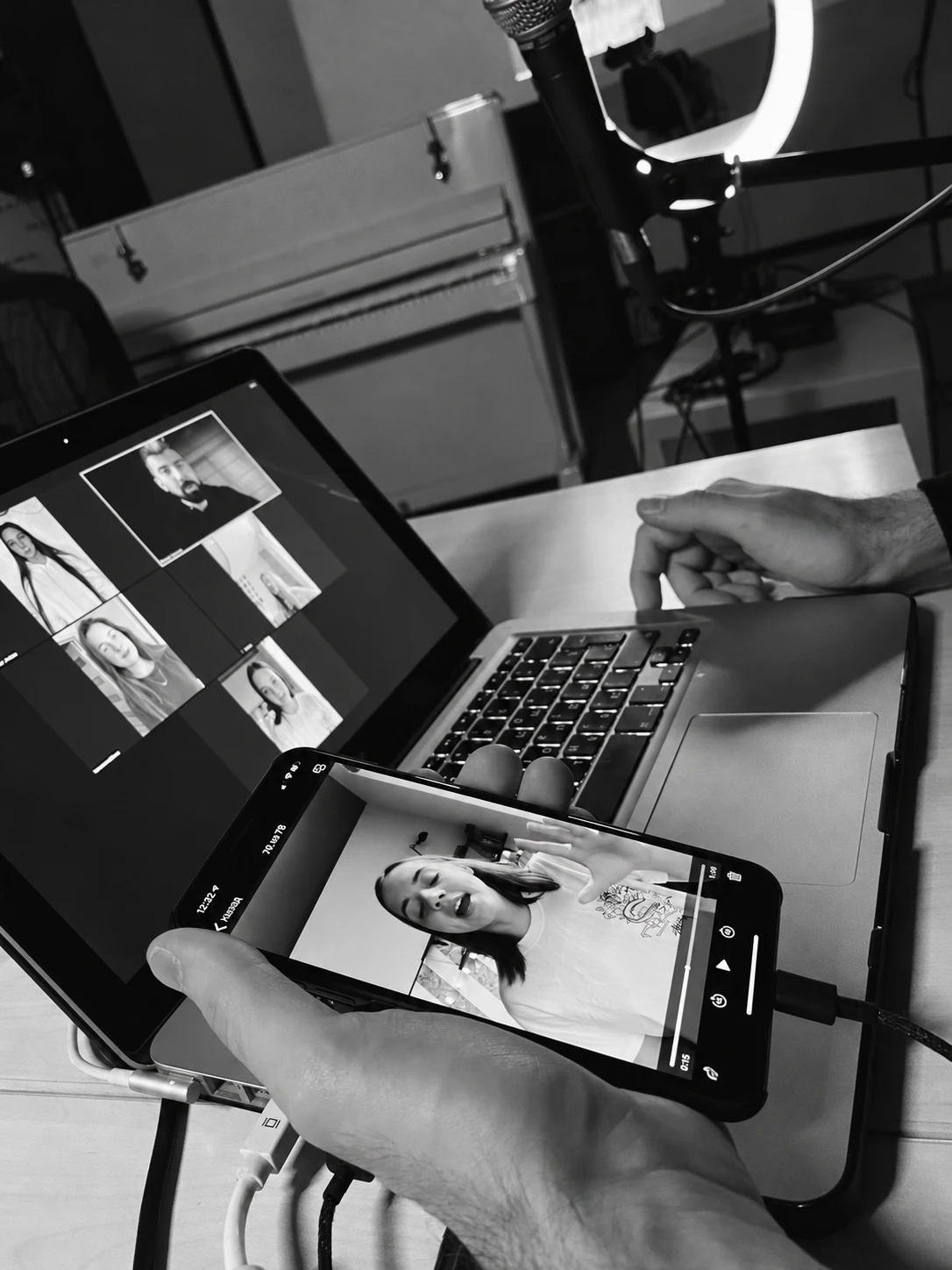 Reviewing a student’s video on a phone during an online lesson